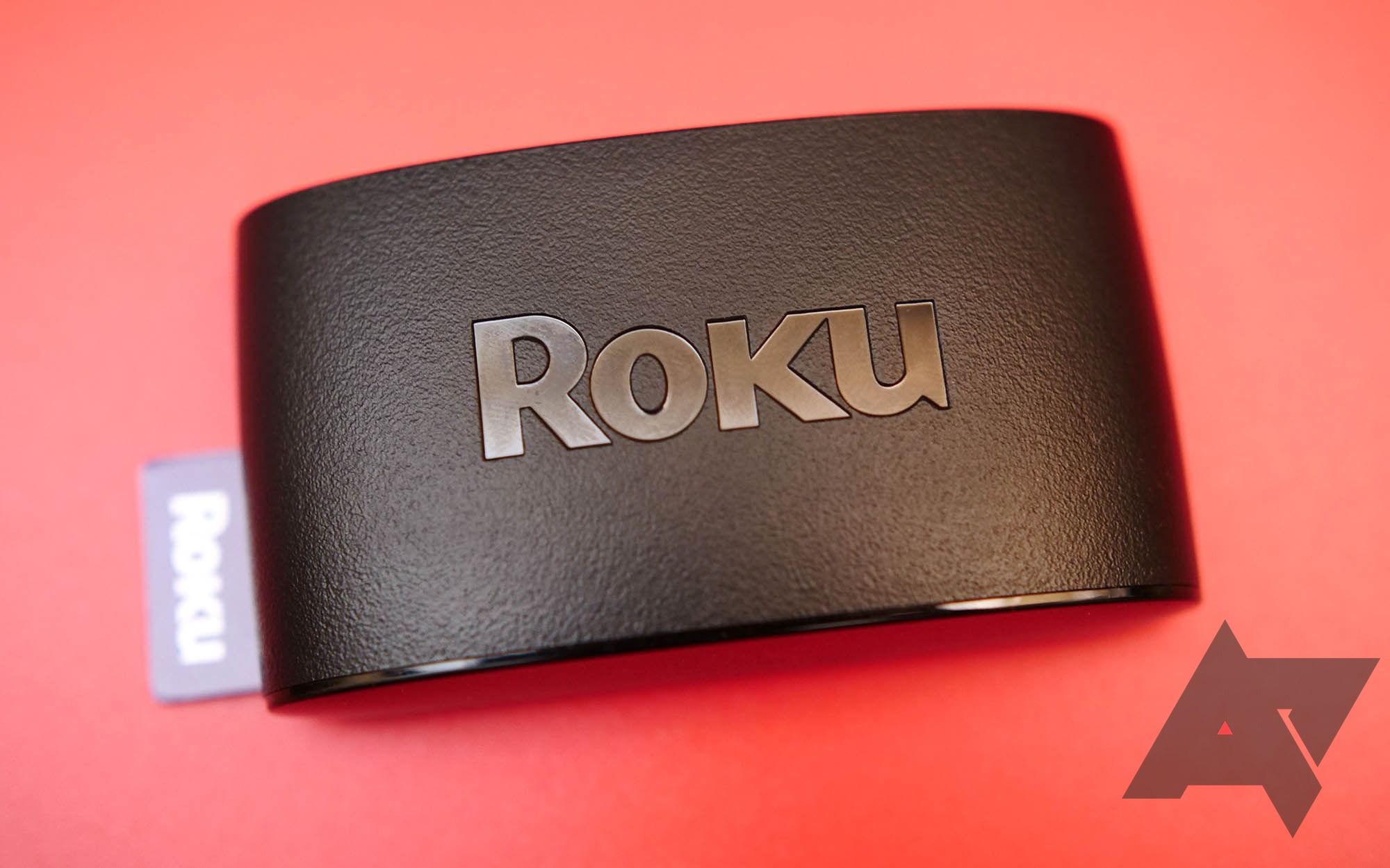 A shaded Roku tool on a red background with the Android Police sign on the bottom lawful