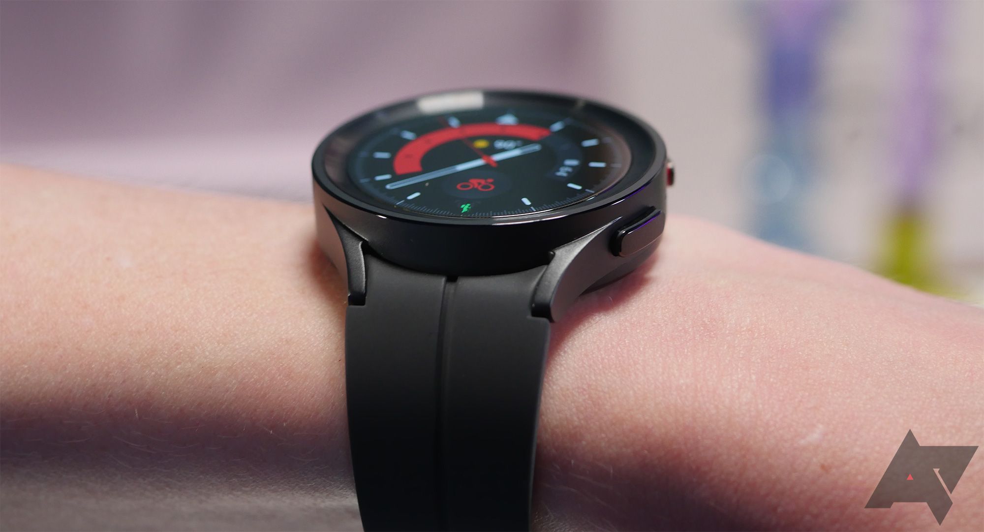 A smartwatch placed on a model's wrist shows how thick the watch is. 