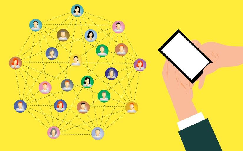 A cartoon of someone holding a smartphone with various contact icons all being connected like a web on a yellow background.