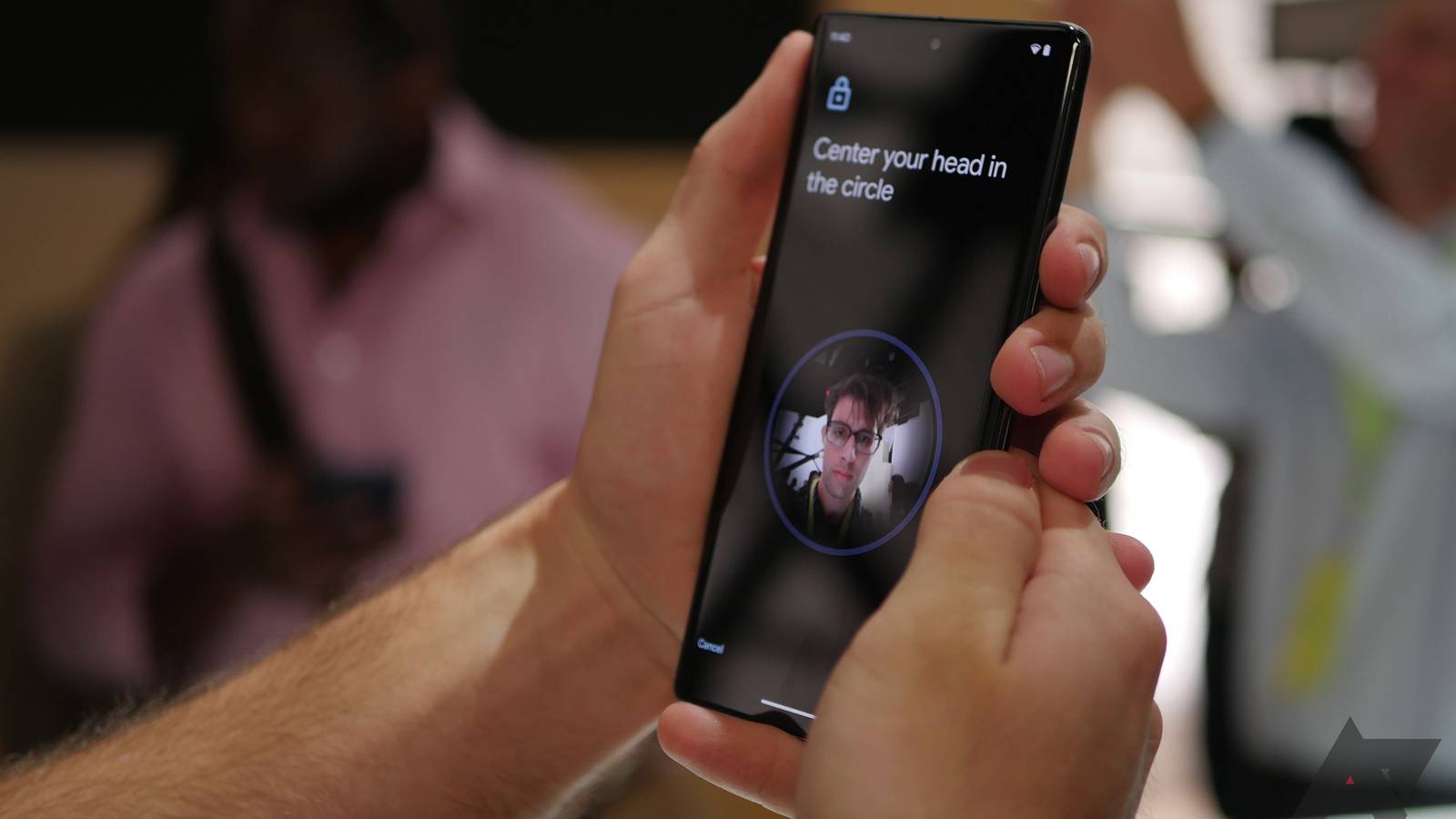 hand holding a Pixel phone showing Face unlock system