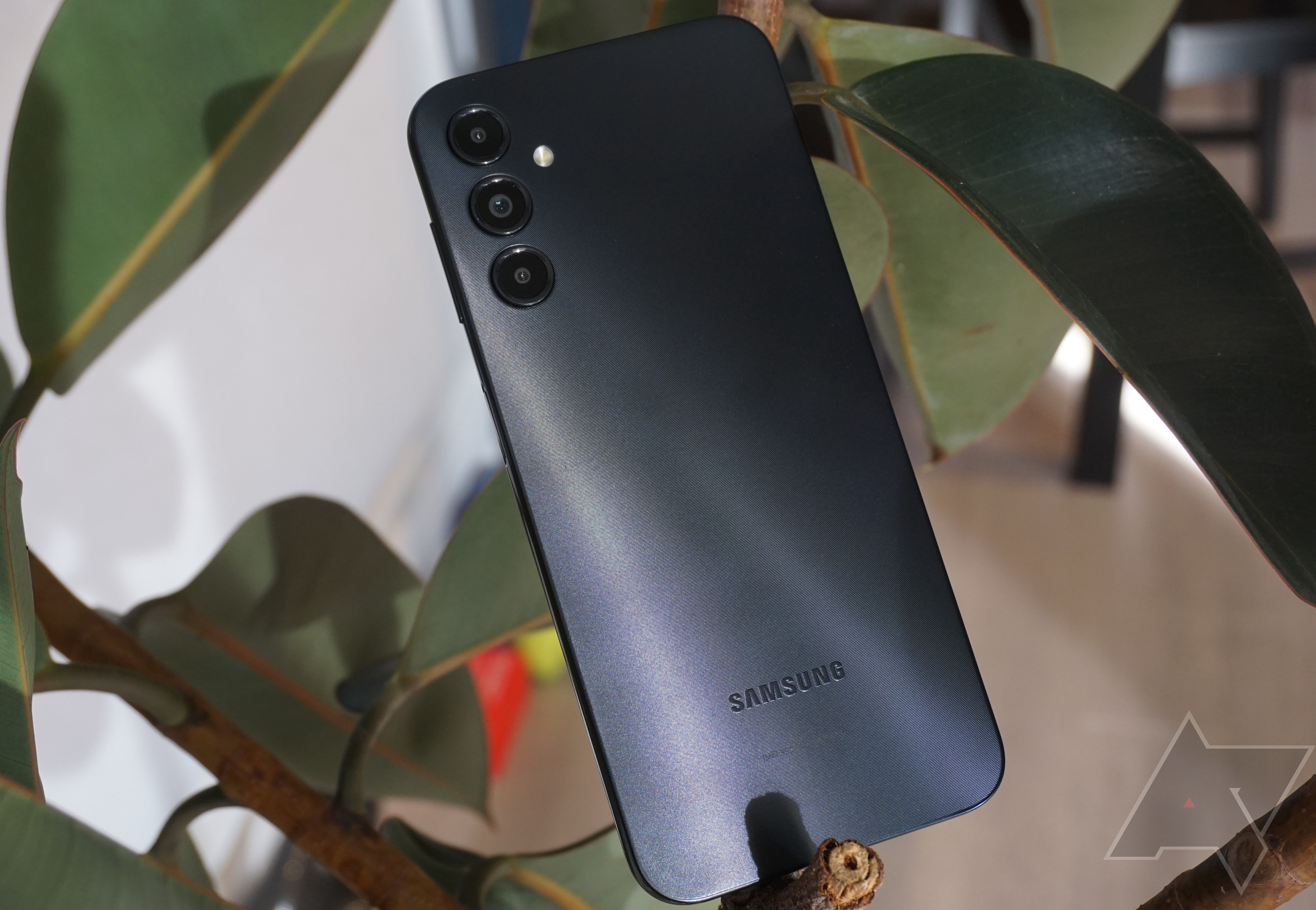 A checklist of the aid of the Samsung Galaxy A14 surrounded by leaves