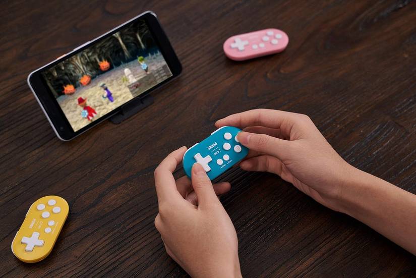 Qualcuno gioca ai videogiochi mobili con il suo mini controller wireless