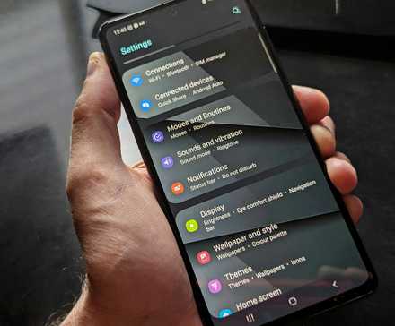 Person holding an Android phone, with the Settings app launched