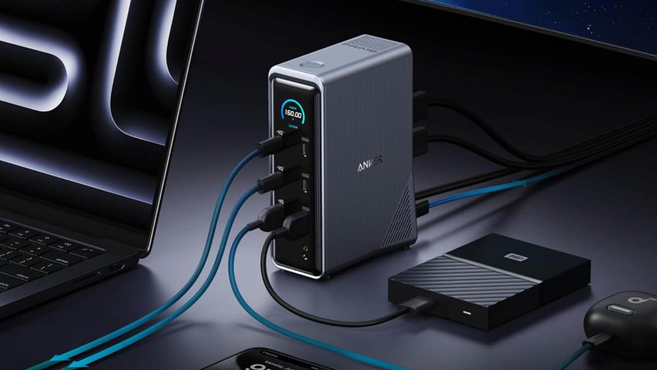 Anker Prime Docking Station with laptop, phone, earbuds, and hard drive plugged in