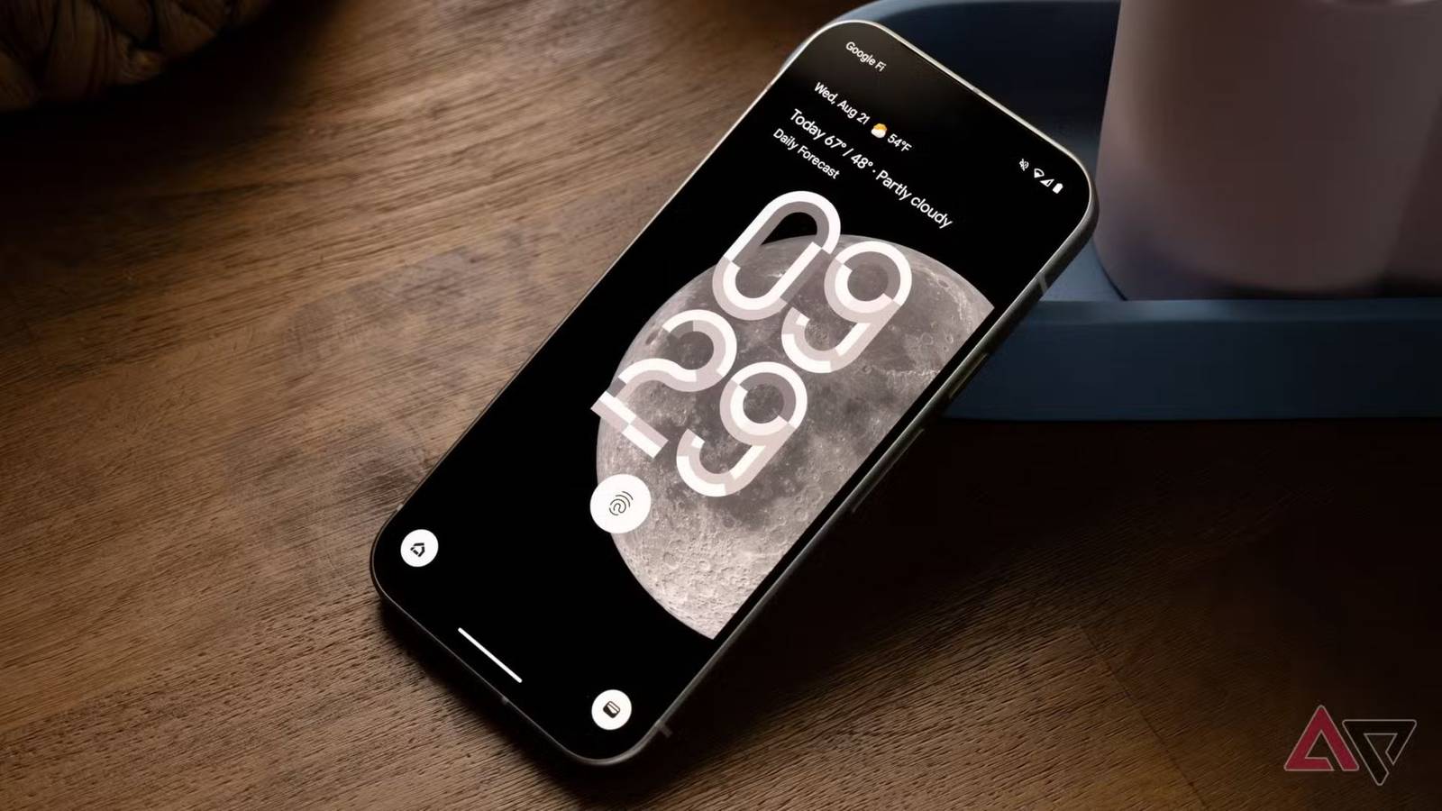 The Google Pixel 9 against a wooden surface