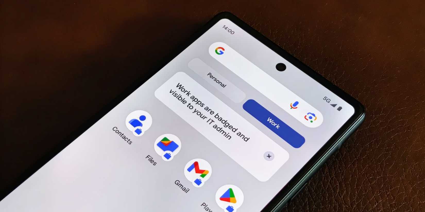 android phone lying on brown leather surface showing apps