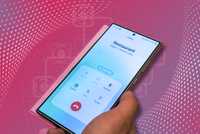 Holding a phone showing a call in progress on a samsung galaxy s24 ultra