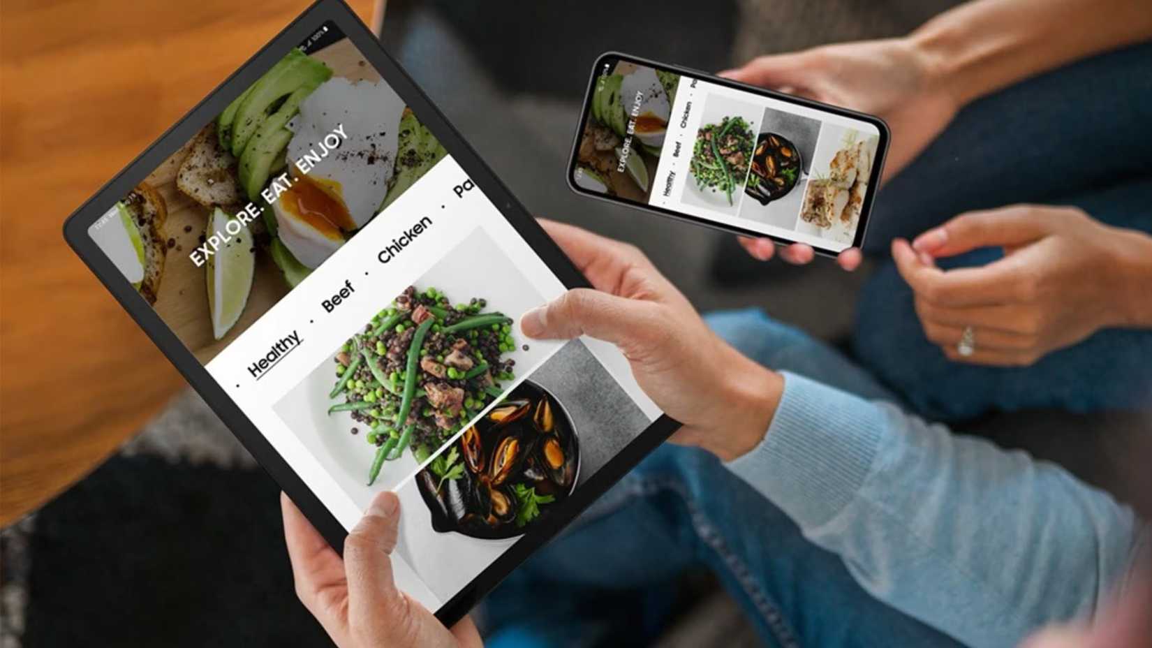 Holding a Samsung Galaxy Tab A9+ with a smartphone alongside it.