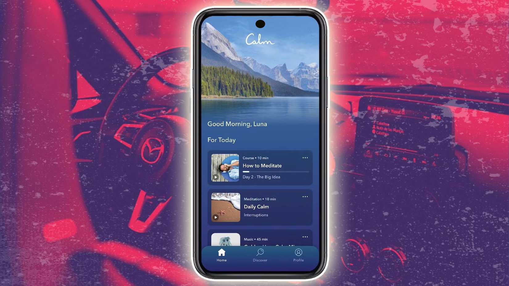 Um smartphone com o aplicativo Calm sobre um fundo vermelho no interior de um carro
