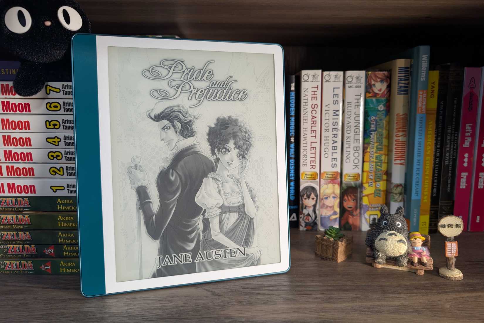 Kindle Scribe (2024) na estante com estatuetas