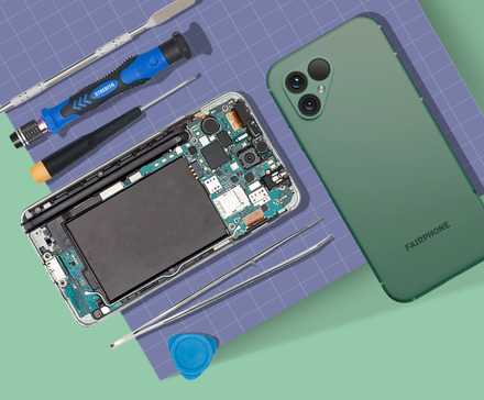 A surface with two smartphones and repair tools