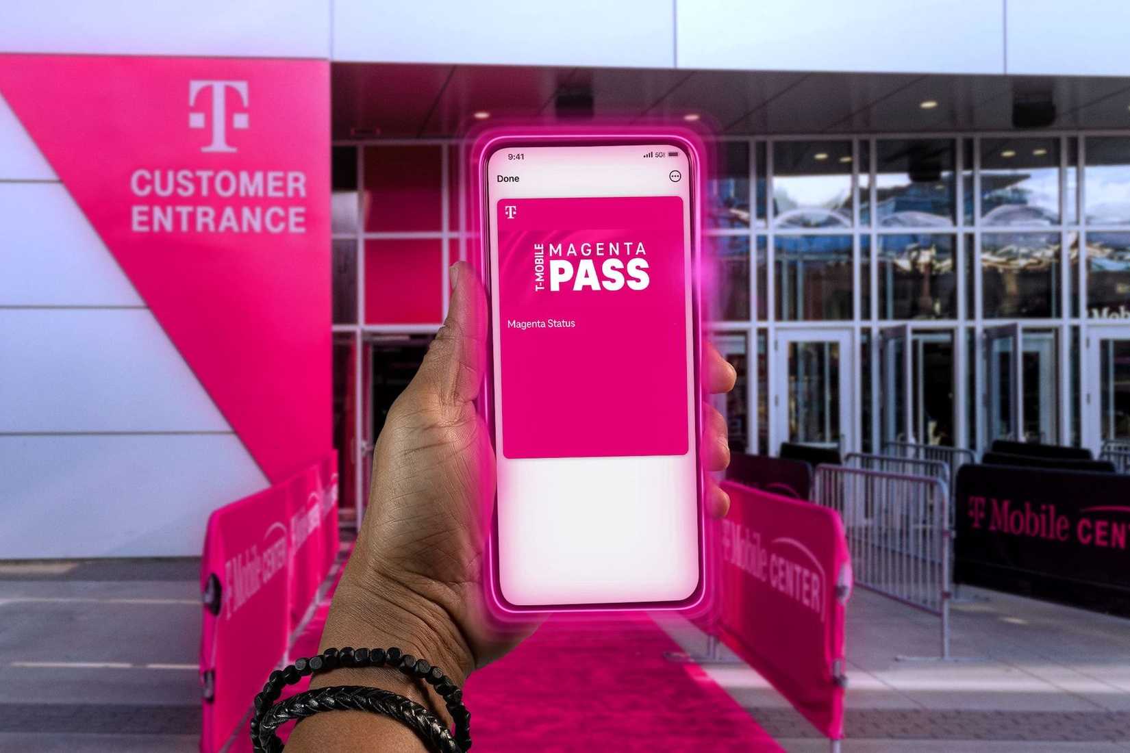 Uma pessoa segurando um telefone com o passe T-Mobile Magenta visível na tela