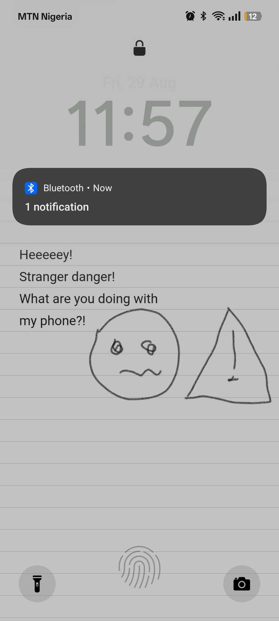 Lock Screen doodle wallpaper showing emoji and warning sign with text asking user to put the phone down