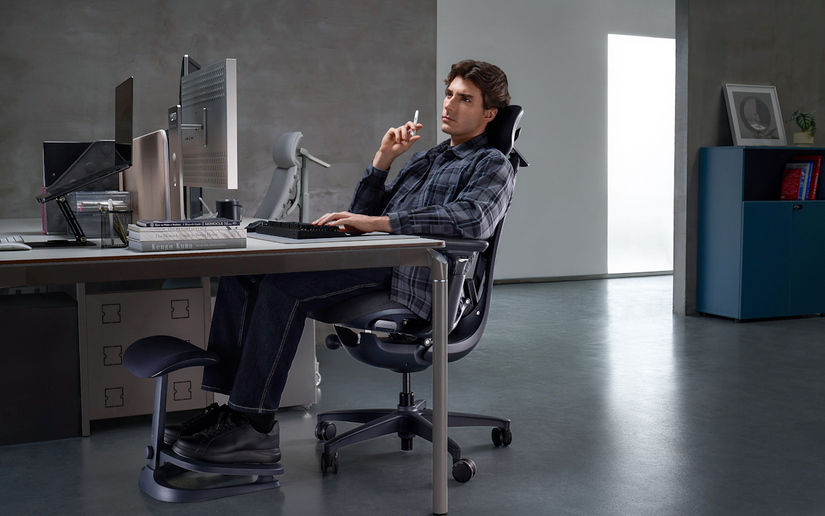 A man sitting on the LiberNovo Omni in his home office