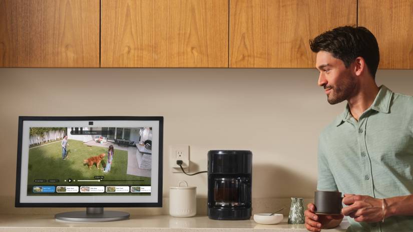a man watches at a smart display showing people in the front yard