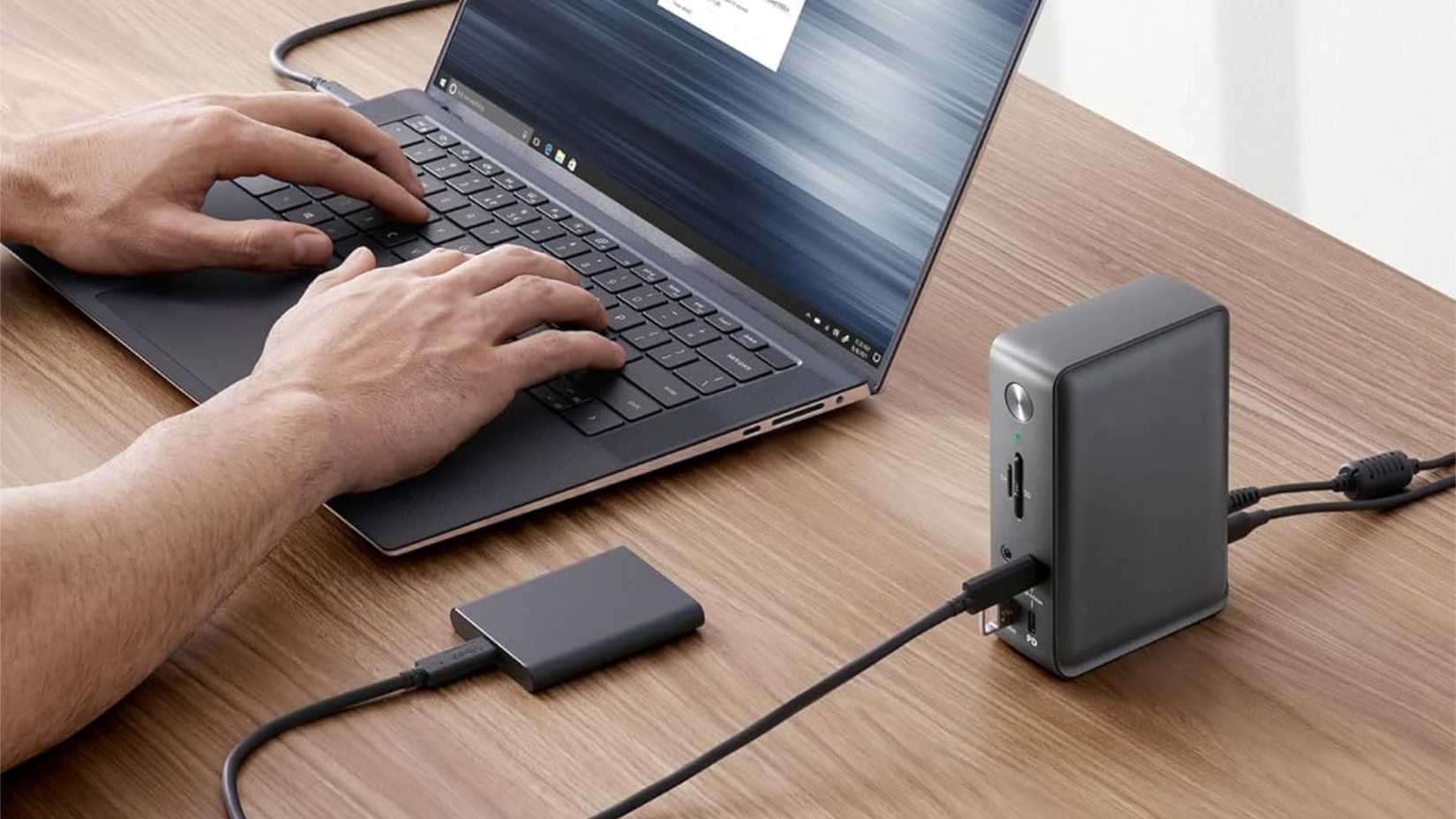 Devices connected to the Anker 575 13-in-1 USB-C docking station on a desk.