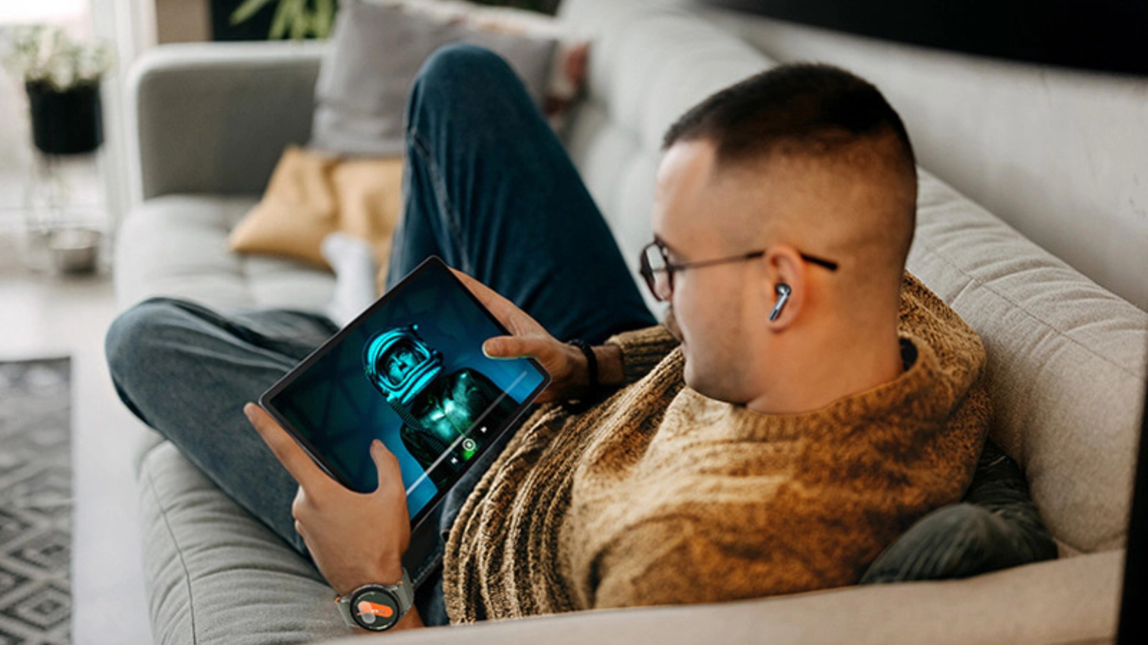 Person using Samsung Galaxy Tab S10 FE on couch