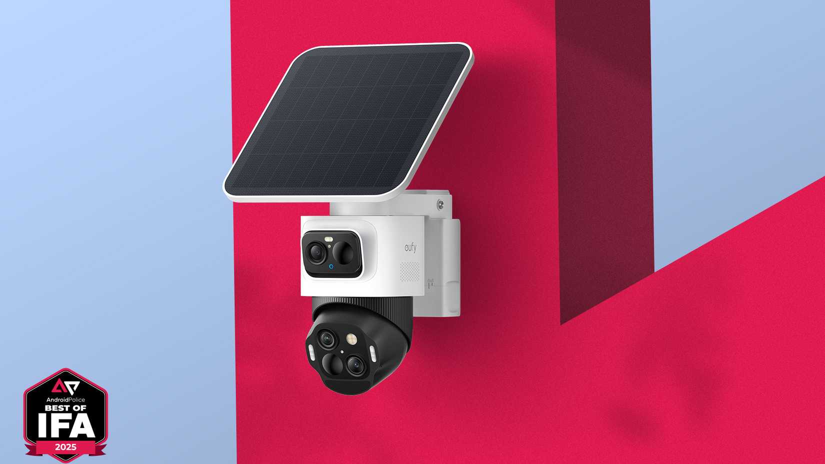 EufyCam S4 security camera with dual lenses and an attached solar panel, mounted on a red wall against a blue background.