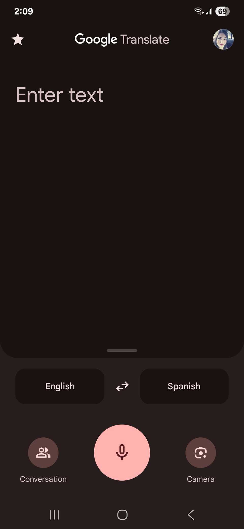 The home page UI of the Google Translate app showing the microphone, conversation and camera buttons at the bottom of the app screen