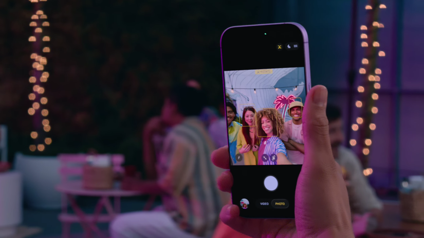 P erson taking a group selfie with an iPhone 17