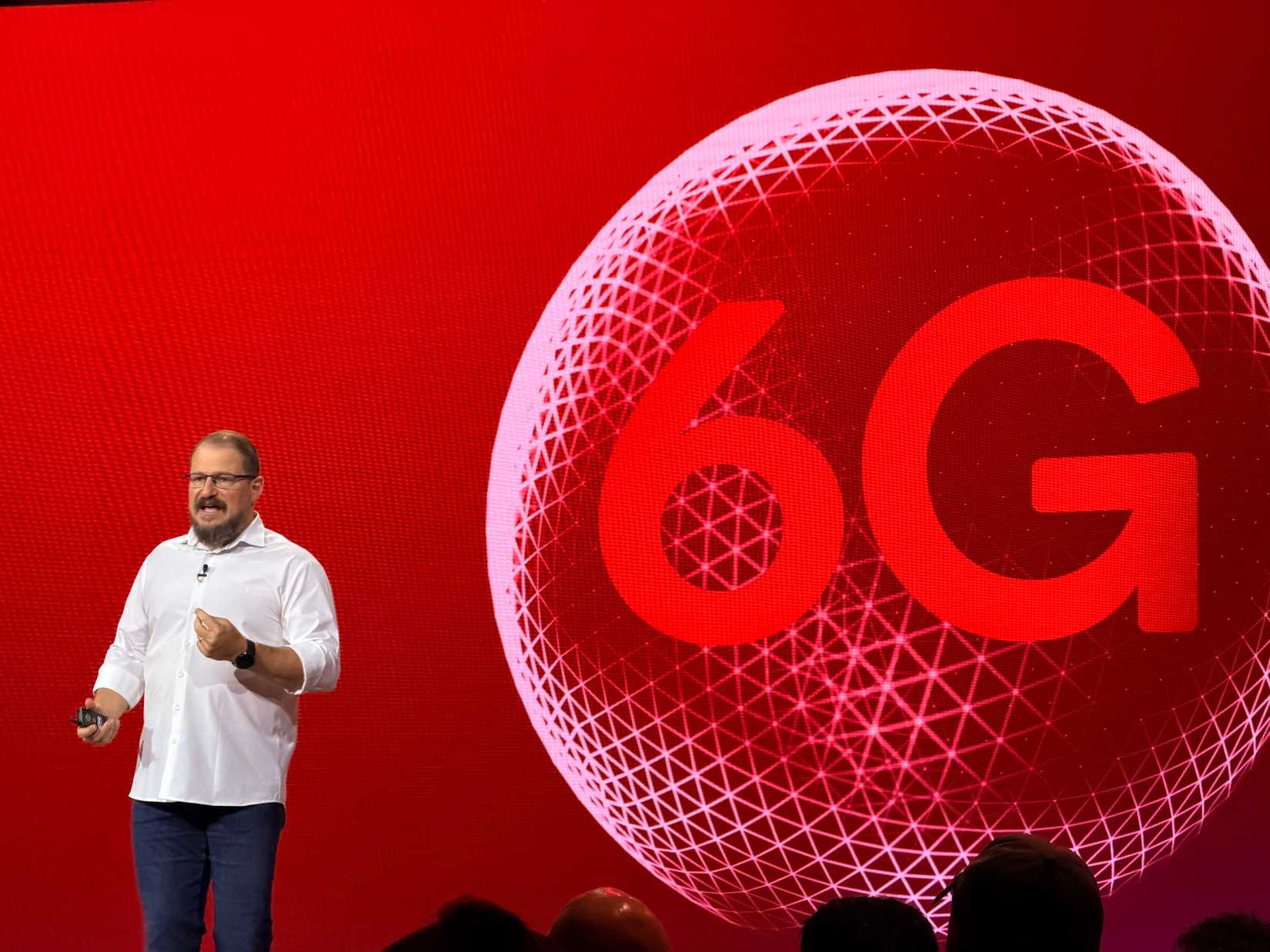 Cristiano Amon, Qualcomm CEO, standing in front of 6G logo