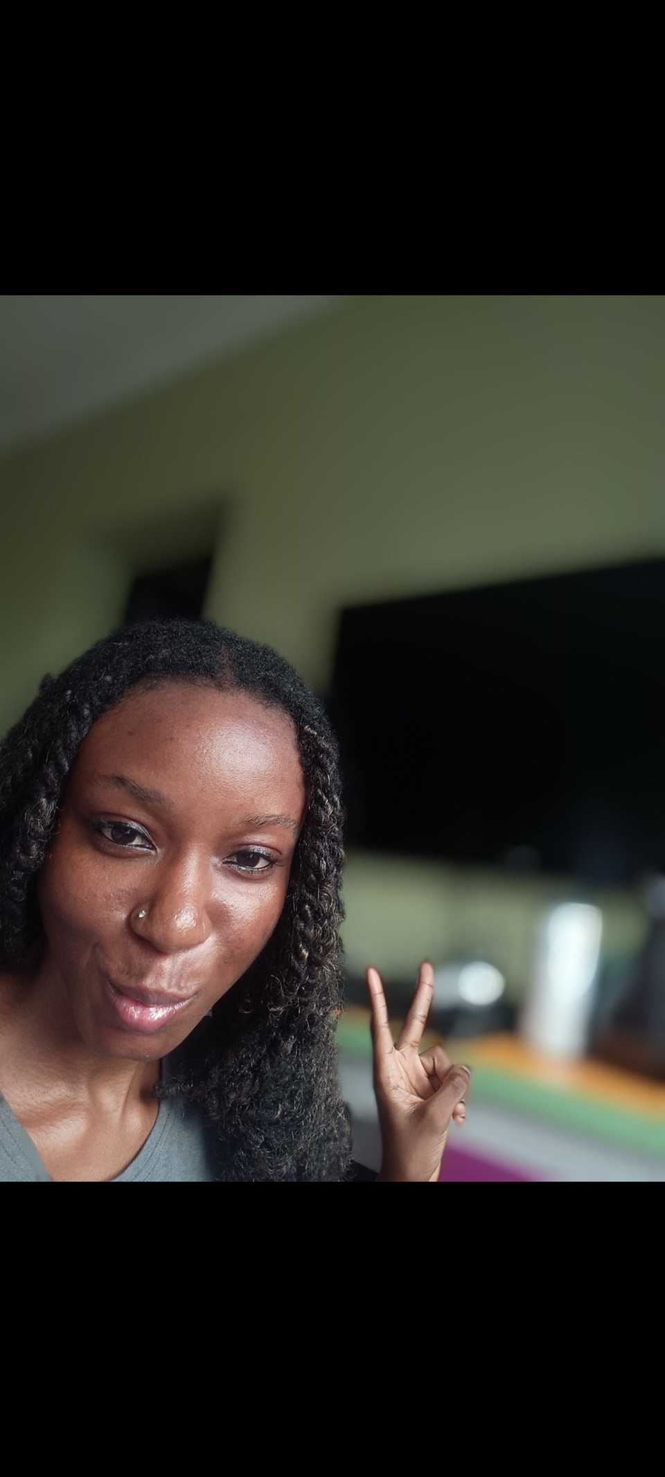Screenshot of woman doing peace sign