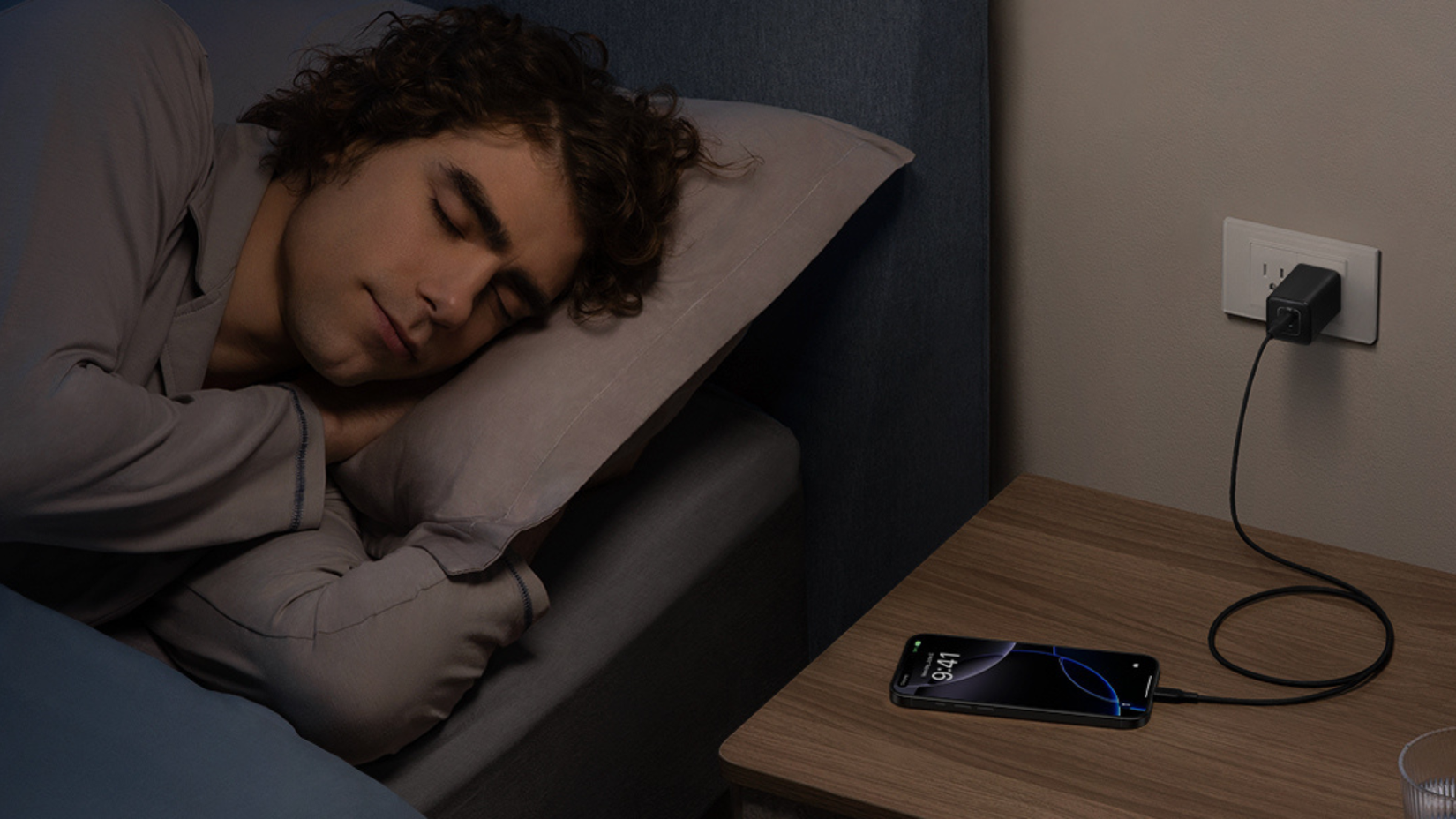Person sleeping next Anker 523 Charger