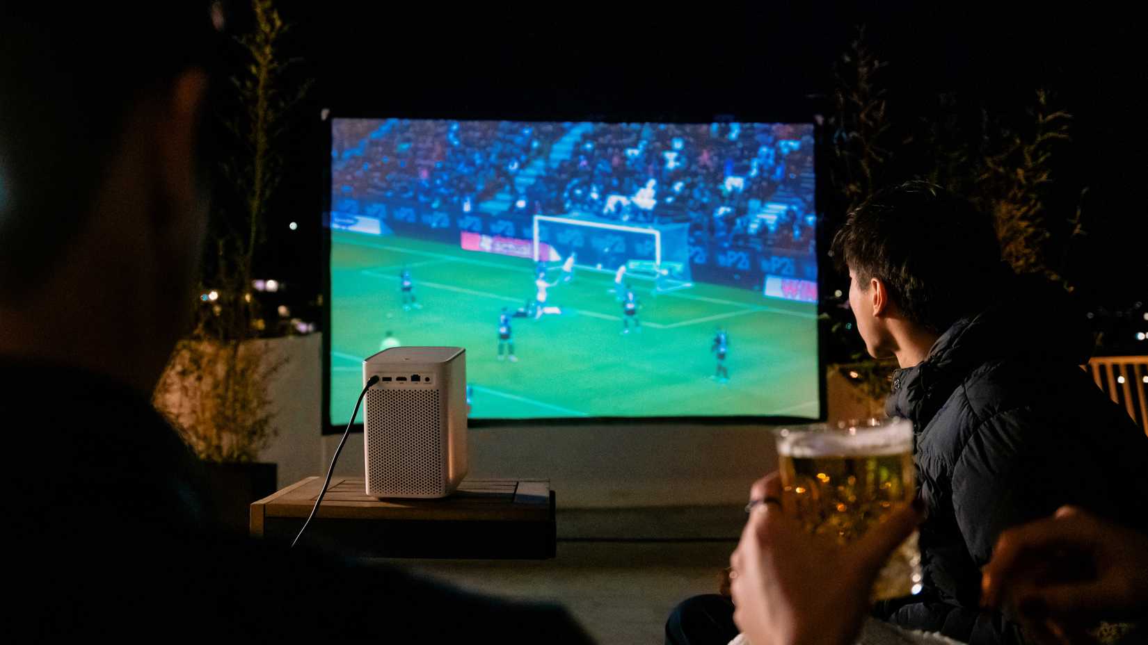 Dangbei N2 projecting a soccer game with onlookers