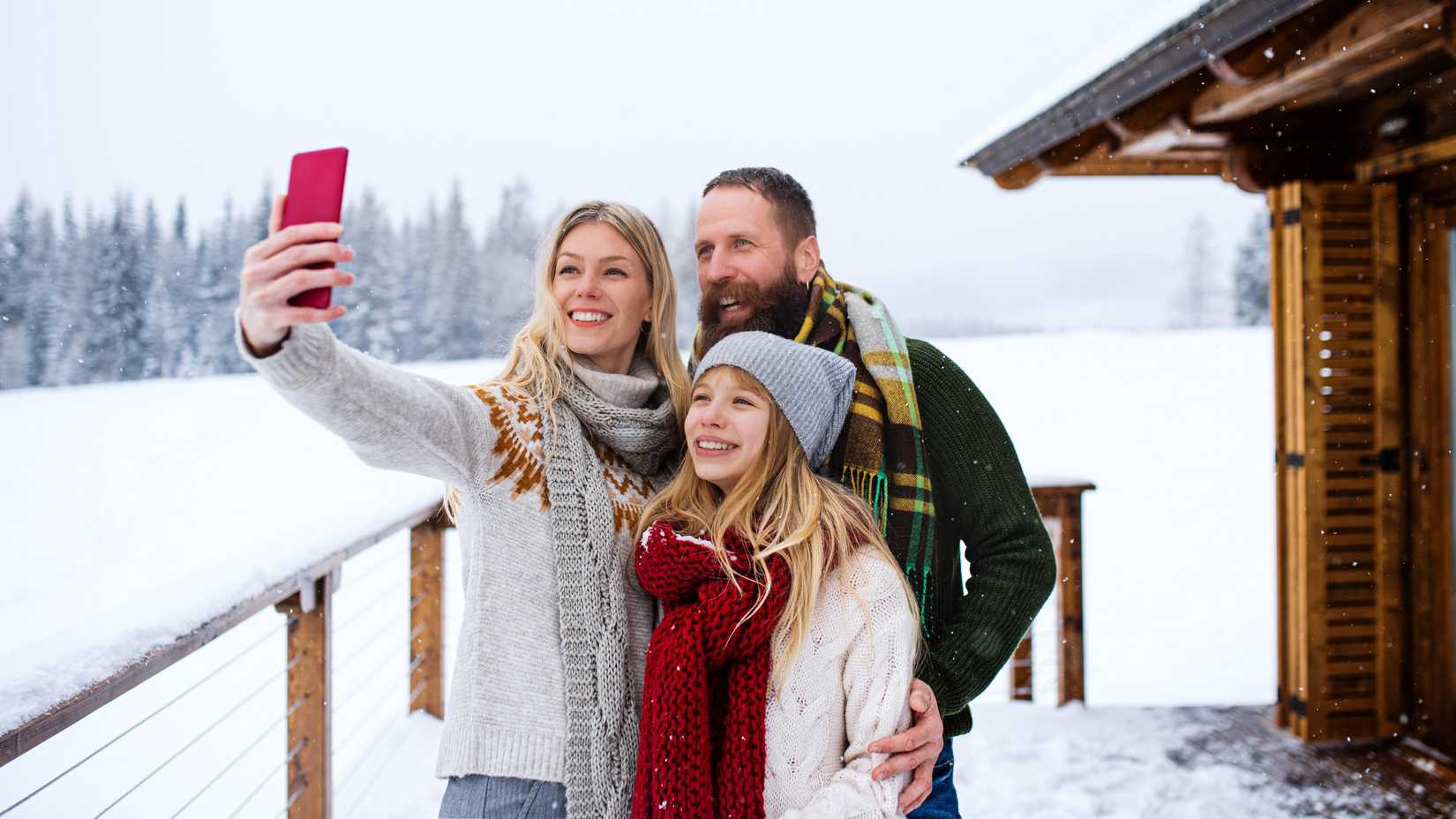 yesim family taking a selfie on a snow-covered porch