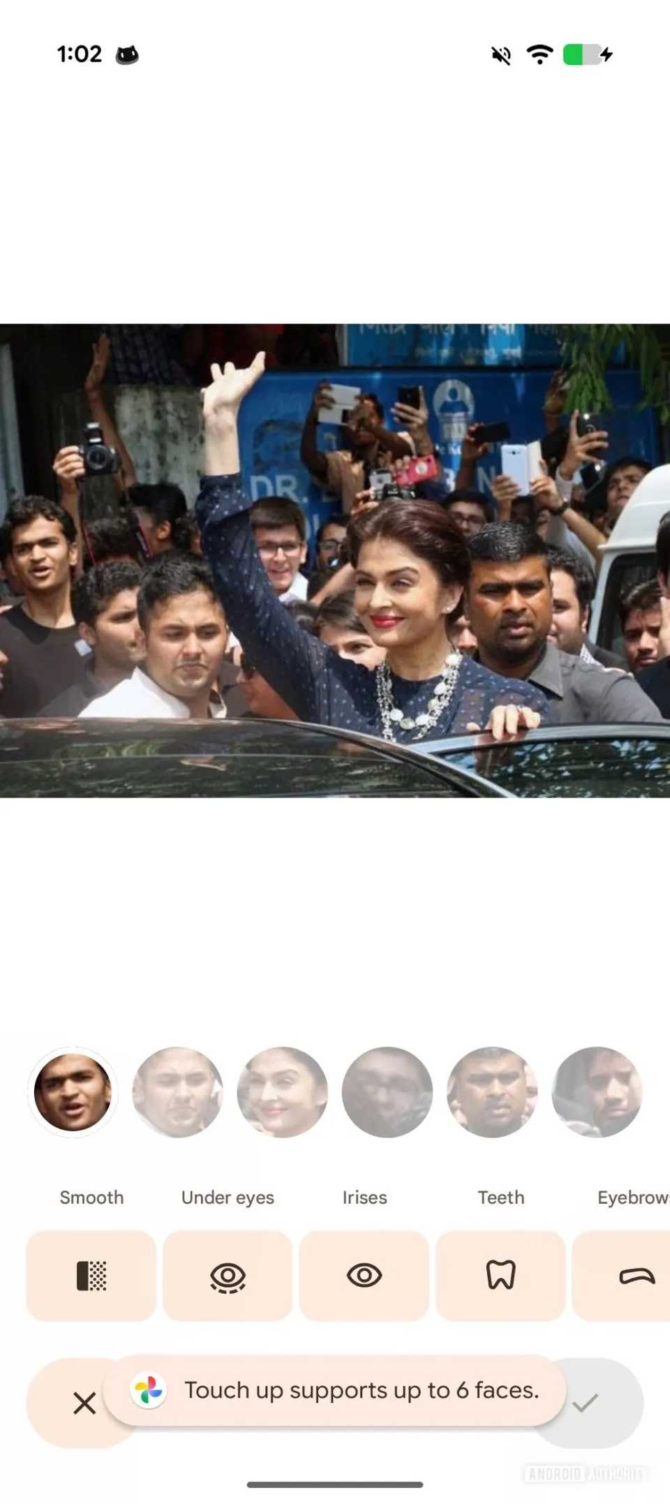 A screenshot showing the Touch Up feature's group face editing feature, with a toast notifying the user of its limits