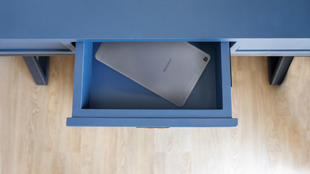 My latest kitchen equipment is an Android pill, and I could not be happier An overhead view of a dusty silver Samsung tablet lying inside an open blue desk drawer.