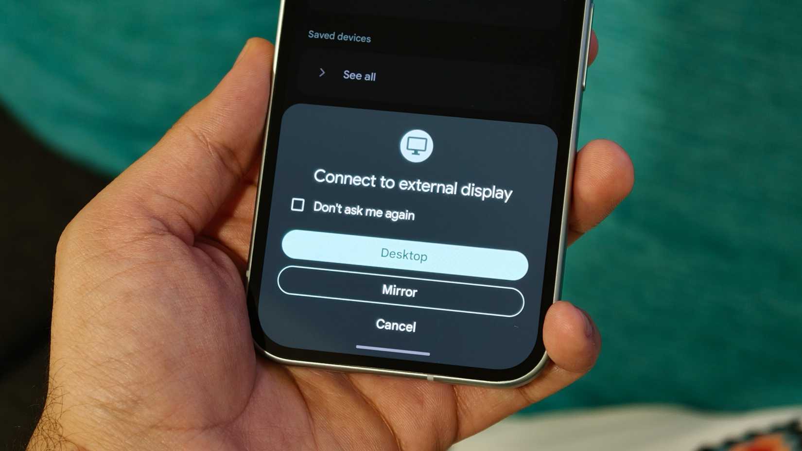 hand holding a pixel phone with external display option for desktop mode