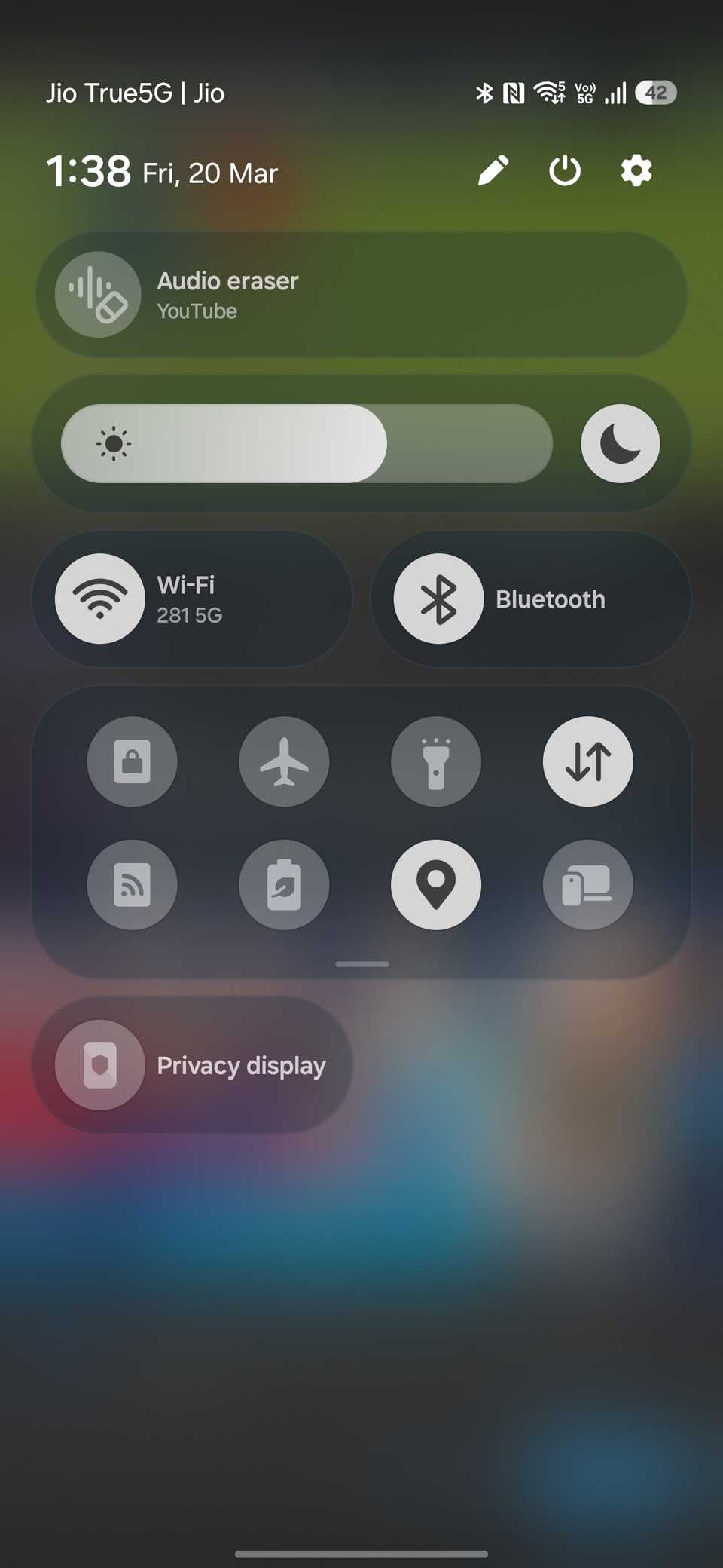 Quick settings panel showing Audio eraser shortcut with brightness and connectivity toggles