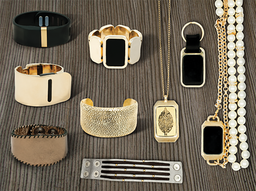 various jewelry pieces from Cuff on a wood background