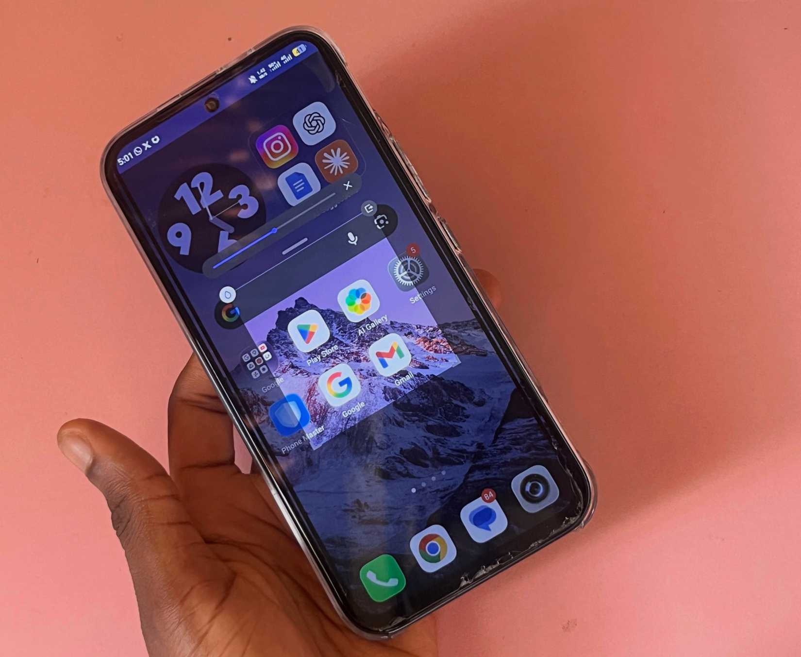 Hand holding phone with Peek Proof privacy feature enable and screen partially dimmed