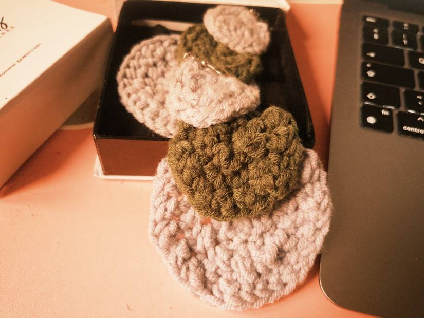 Green and grey earring pair resting inside open box