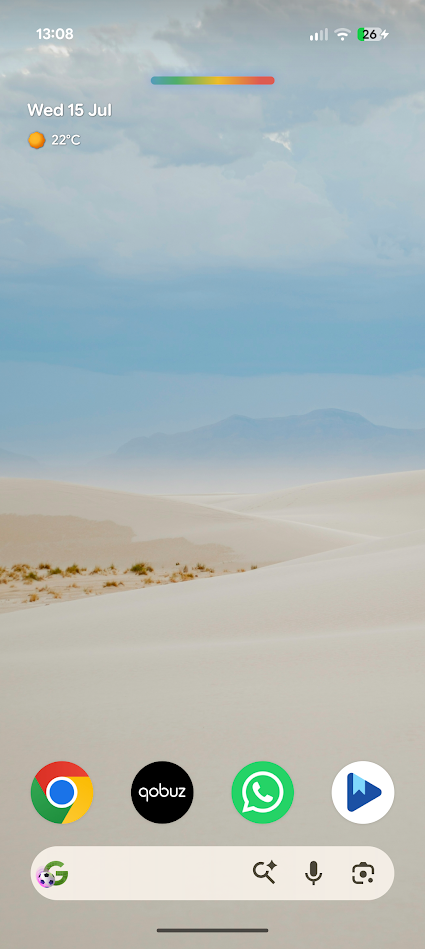 wallpaper of sandy dunes and blue sky with apps at bottom of screen