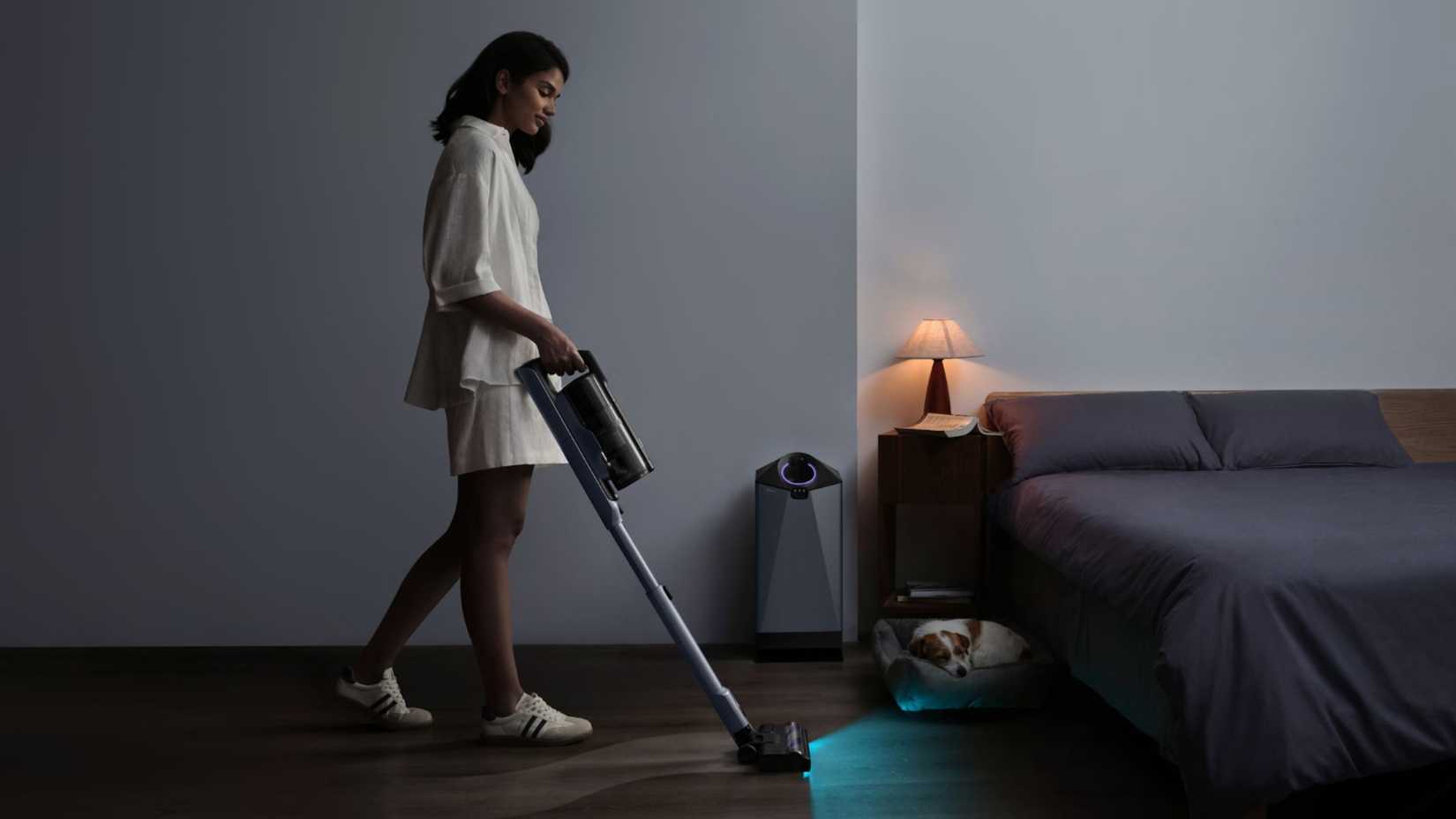 Person using Narwal V50 Cube in bedroom near dog