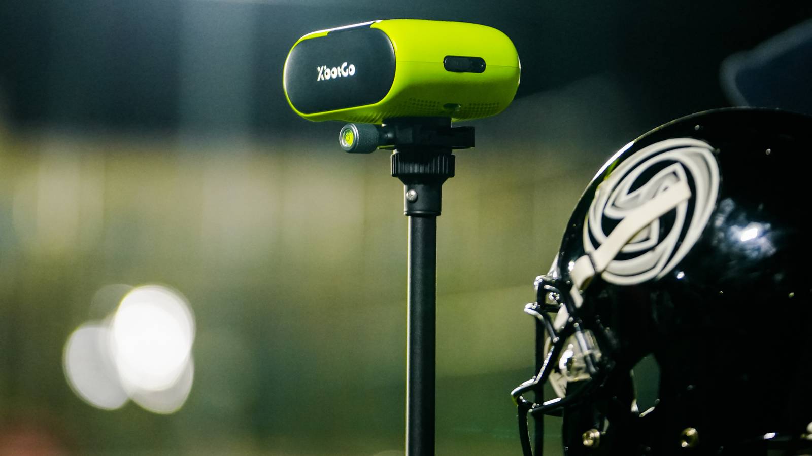 The XbotGo Falcon next to a football helmet.