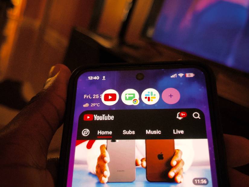Smartphone home screen showing app bubbles and a minimized YouTube feed