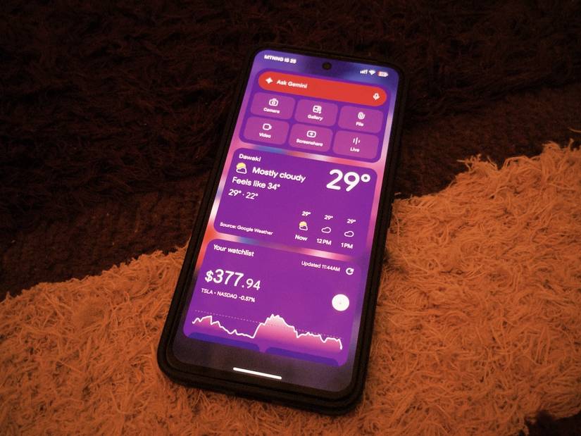 Pixel 8 phone on carpet showing lock screen widgets