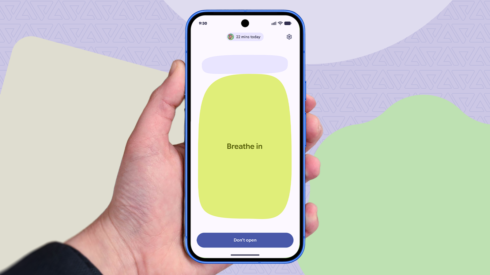 Hand holding a Pixel phone showing the Pause Point breathing exercise.