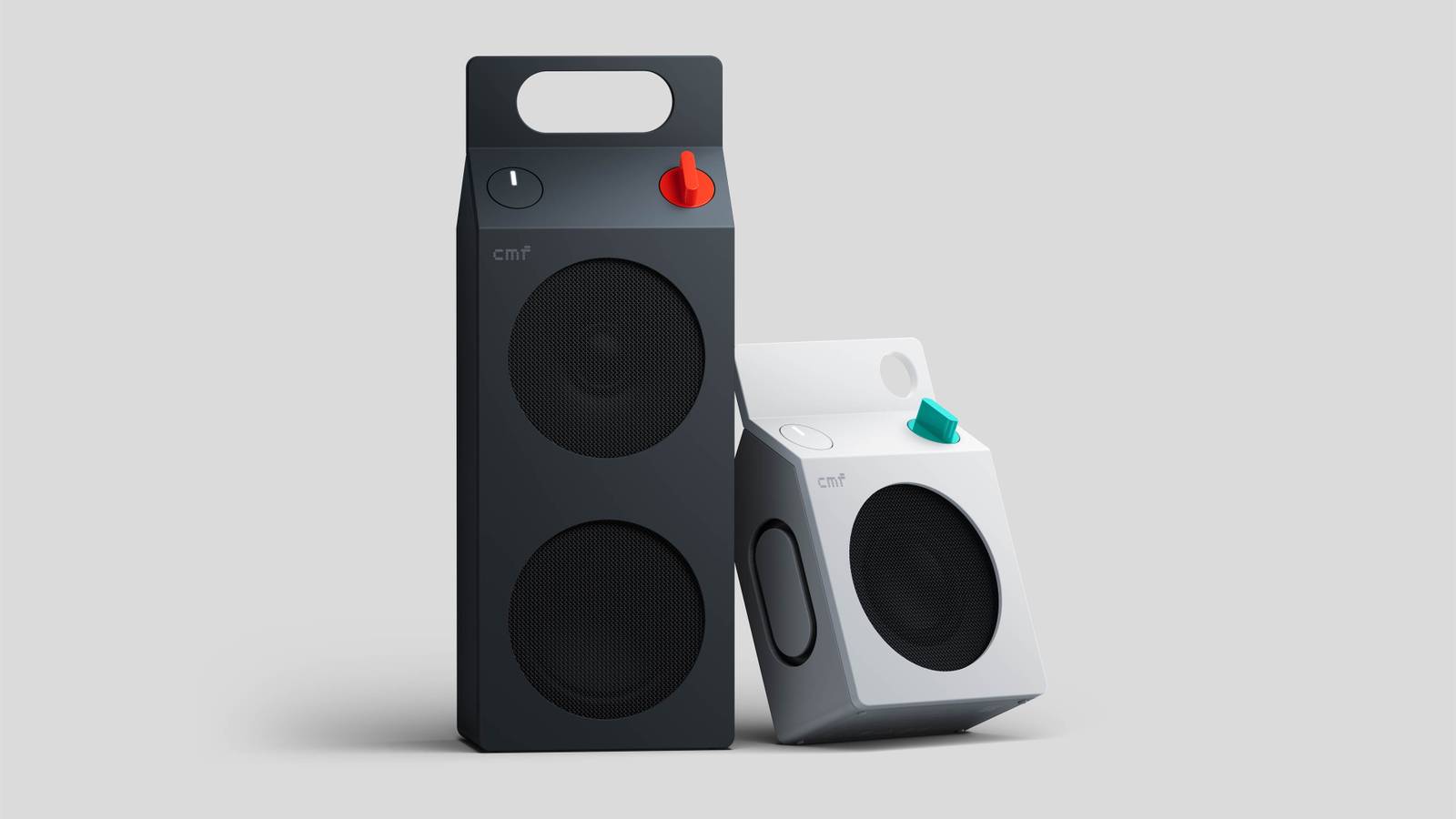 Dark grey and white CMF portable speakers with integrated top handles on grey background