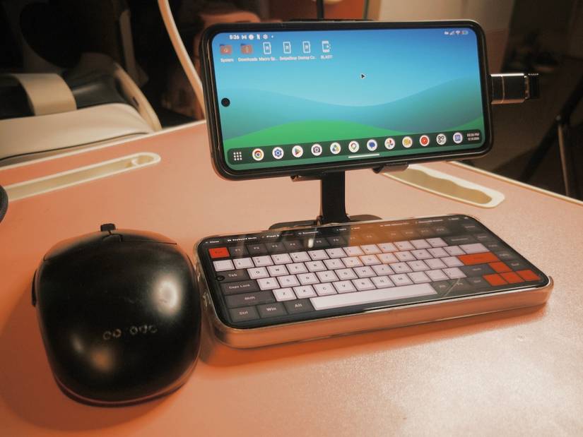 Portable desktop setup with keyboard phone and mouse beneath mounted phone display