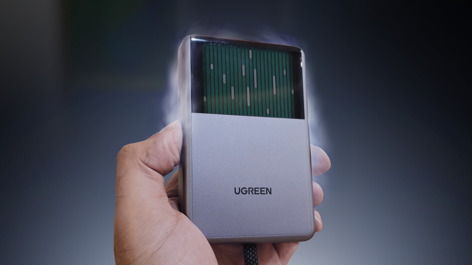 Hand holding a UGREEN MagFlow Pro liquid-cooled power bank.