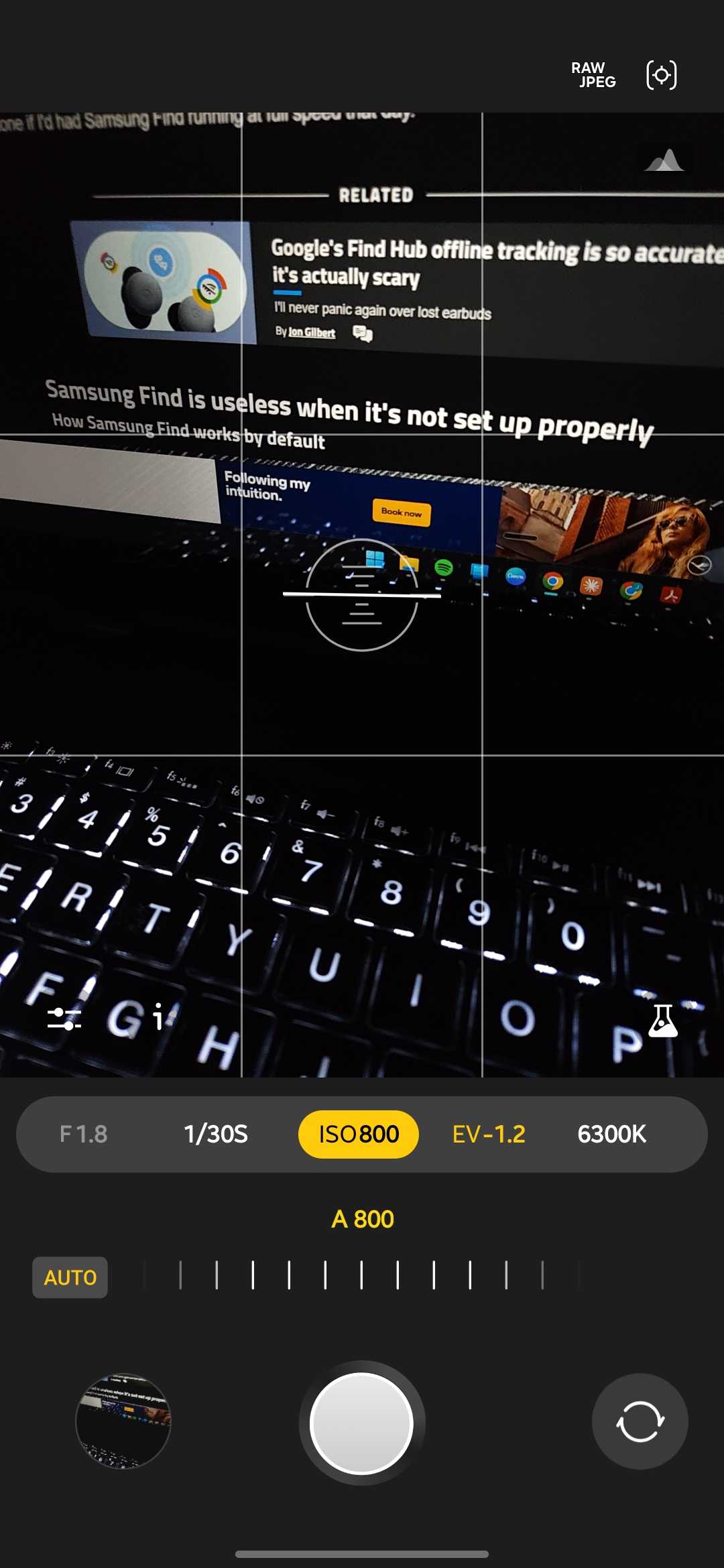 Expert RAW camera app with the ISO control selected and set to auto at ISO 800 framing a backlit laptop keyboard and screen