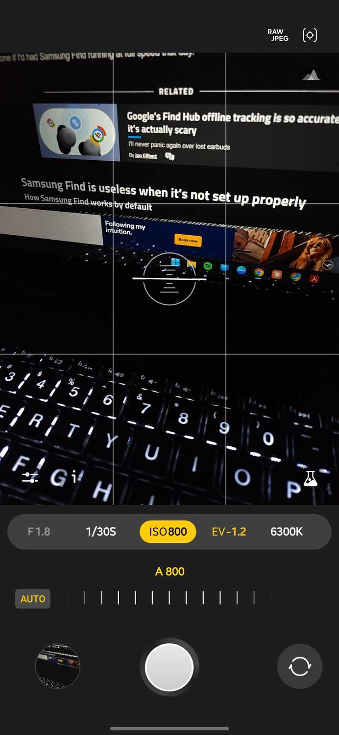 Expert RAW camera app with the ISO control selected and set to auto at ISO 800 framing a backlit laptop keyboard and screen