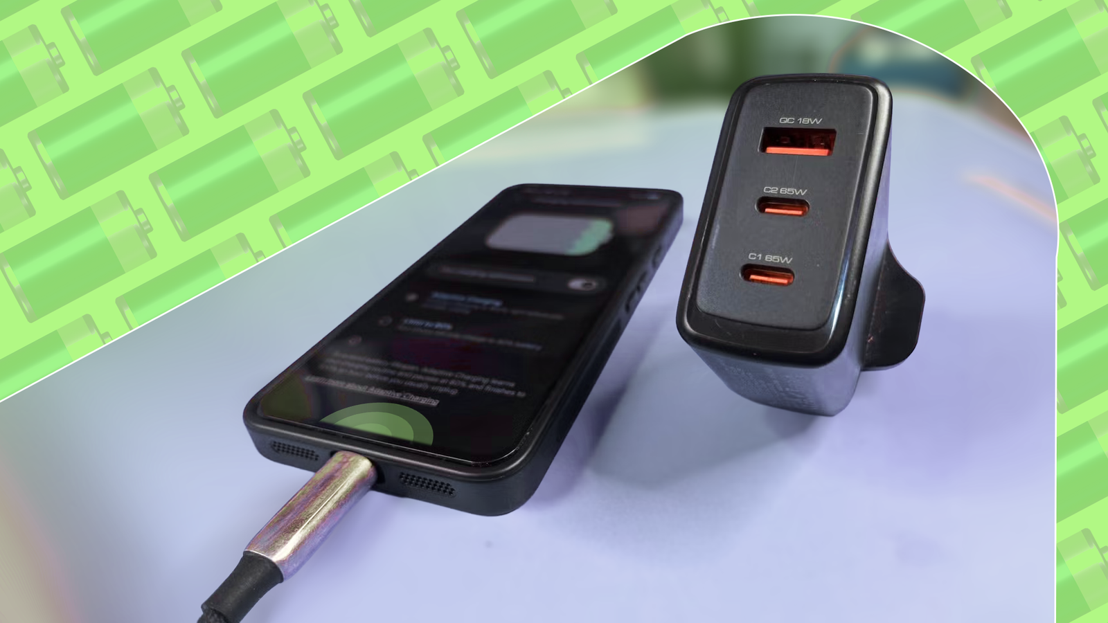 Smartphone connected to a USB-C cable beside a multiport fast charger.