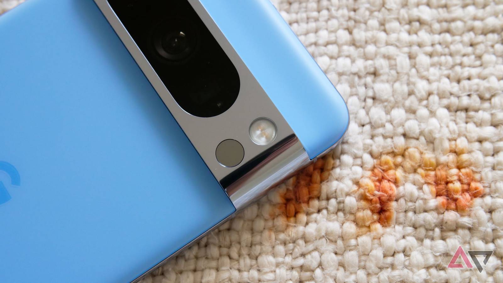 Blue Google Pixel 8 Pro face down on carpet