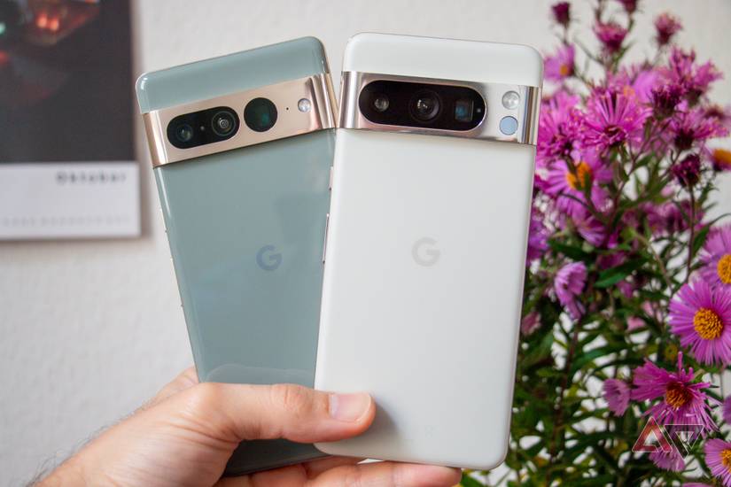 Google Pixel 7 Pro and Pixel 8 Pro being held in one hand next to each other.